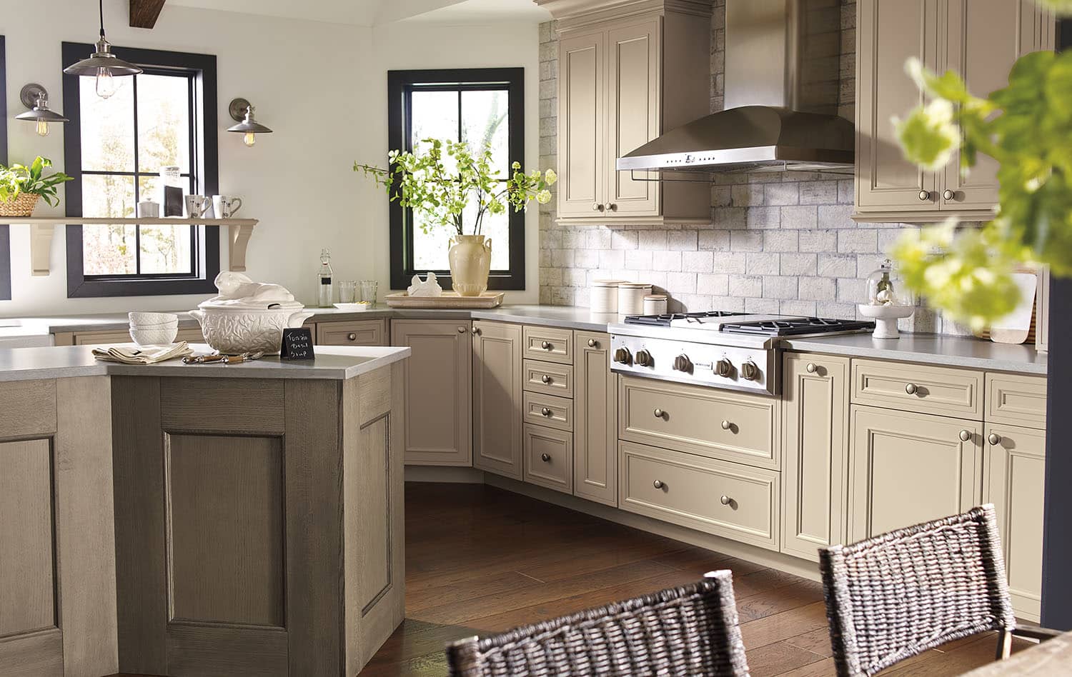 Greige kitchen cabinets with a subway-tile backsplash and island